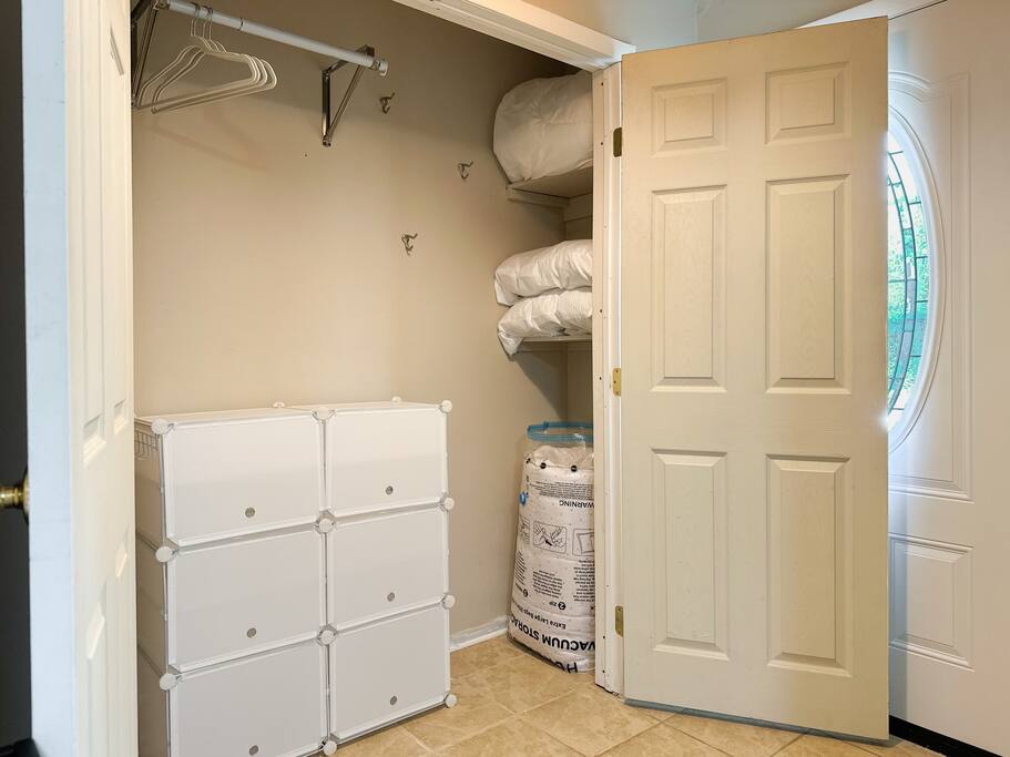 The entryway closet holds the pillows and blankets for our comfy sleeper sofa. There is also a mattress topper to go with the sleeper sofa.