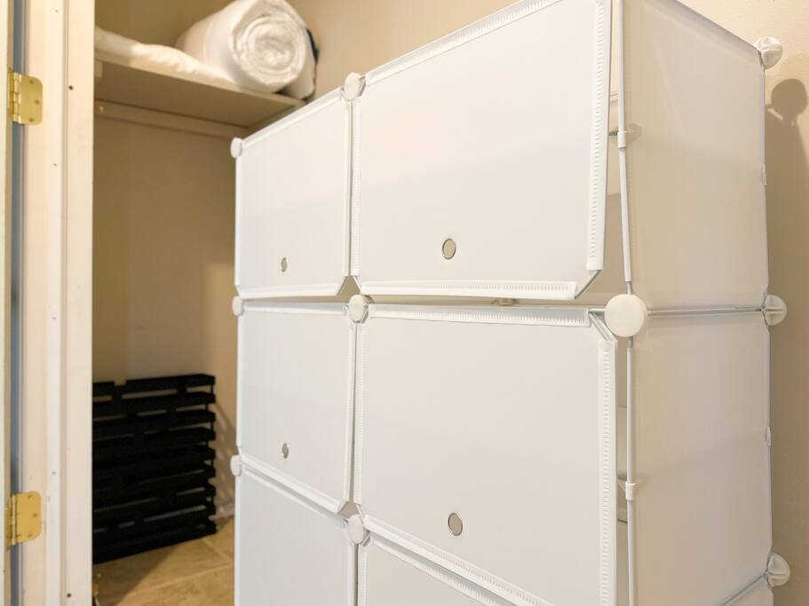 Convenient storage closet with shoe holder and umbrella holder.