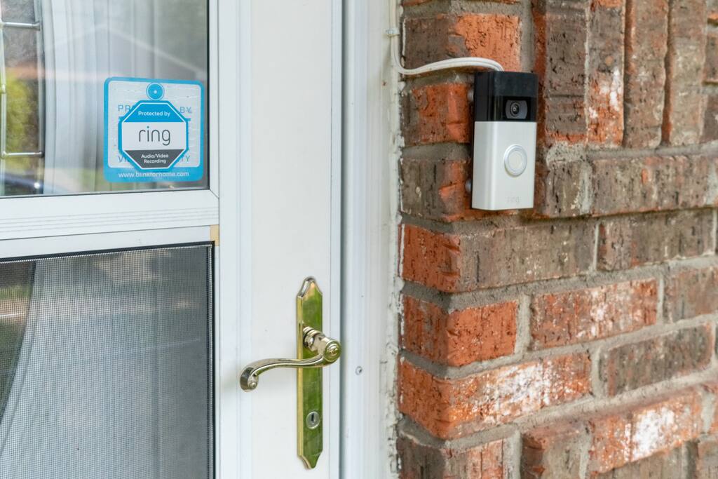 A Ring doorbell camera is at the front entrance. The camera is actively recording during your stay. It records both audio and video.
