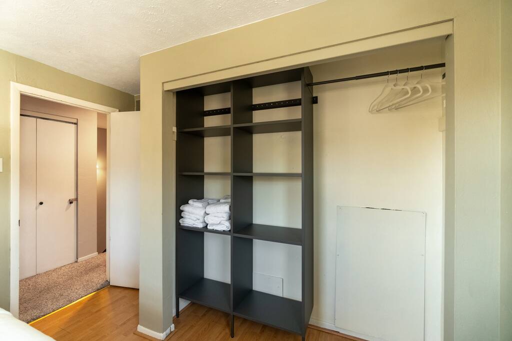 Open closet space with provided non-slip velvet hangers.