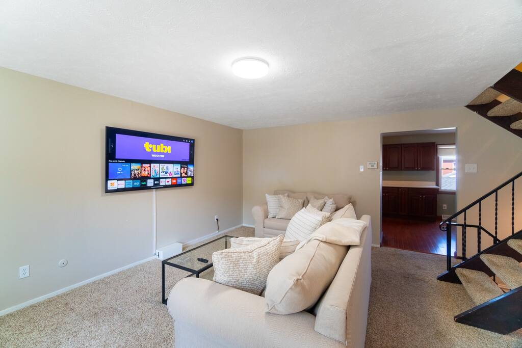 Cozy and spacious living room where you can enjoy Netflix, Amazon Prime, and others on our 65" screen TV. Sit back, relax, and unwind on our comfortable sofa and loveseat. 