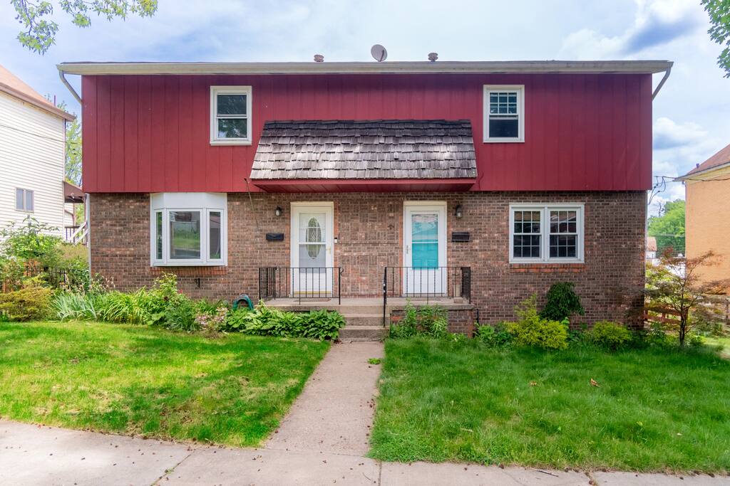 Access to the Airbnb is at the white door on the left side of the house.