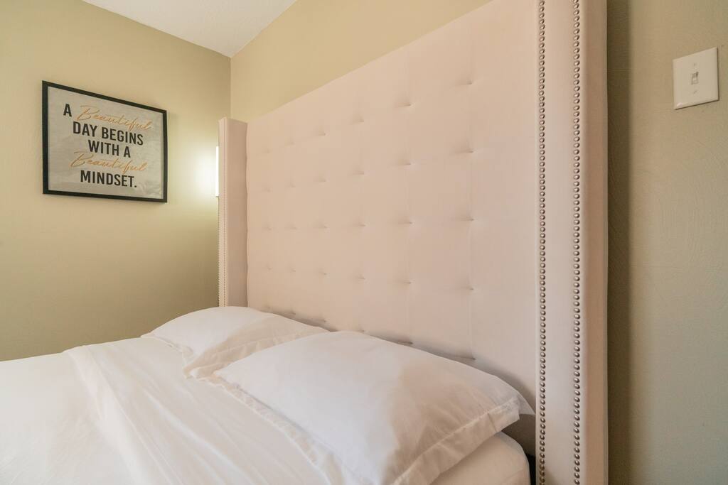 The upholstered headboard brings a comfortable feel and modern refinement to this queen bed.