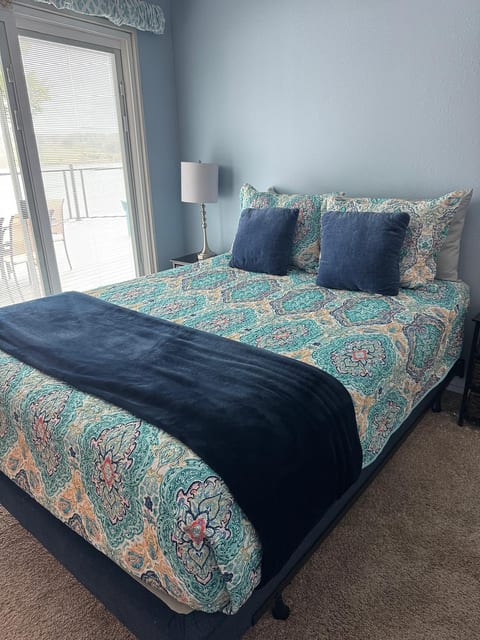 Sunny bedroom with deck access, plush king bed and serene blue palette