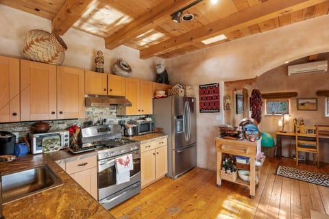 Charming kitchen with wood finishes, stainless appliances, and warm tones—fully stocked for your stay.