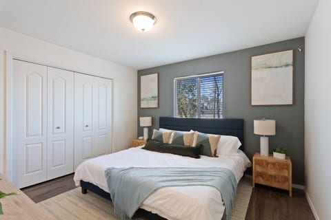 The stylishly decorated bedroom is your tranquil retreat, featuring a plush king-sized bed, blackout curtains, and soft lighting. Unwind in this cozy, modern space after a day of exploring.