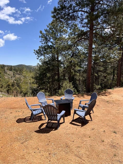 Mountain view seating area with tall pines and open sky—perfect for unwinding after a day of exploring.