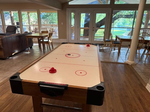 Challenge your friends and family to a game of air hockey. You can also relax in the spacious living area with large windows, making your stay fun and memorable.