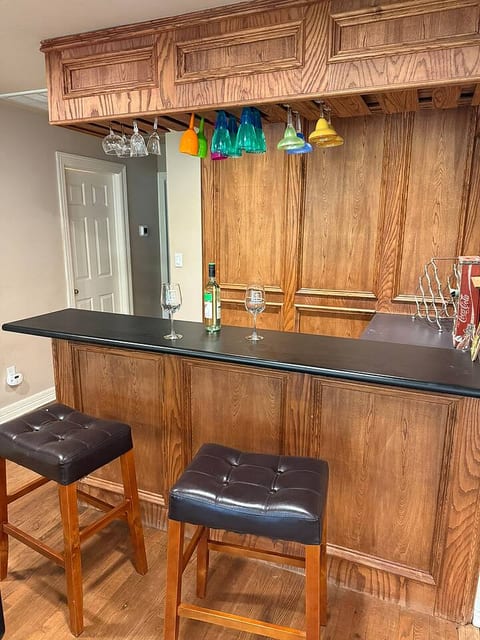 The home features a private bar area for you to enjoy. Sit on the comfortable leather stools and unwind with a drink after a day of exploring.