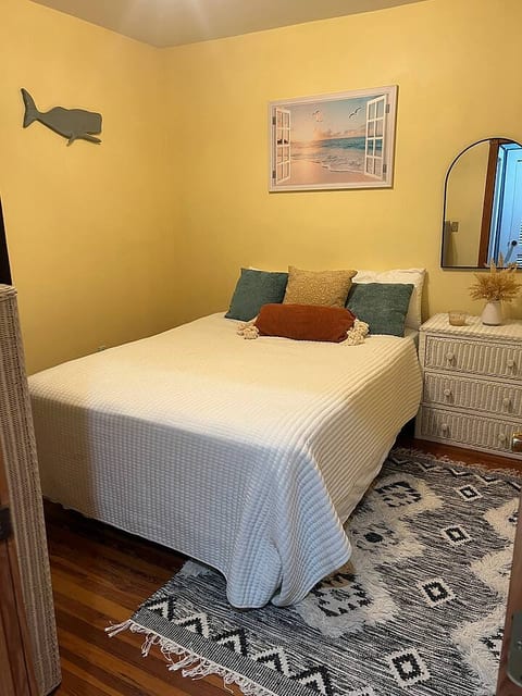 Unwind in your cozy private room featuring a comfortable queen-size bed, warm lighting, and unique coastal decor. A perfect retreat after a day of exploring.