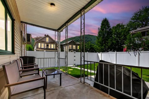 Imagine yourself relaxing on a covered porch, enjoying a beautiful mountain view as the sun sets. This private outdoor space, complete with comfortable seating and a stunning backdrop, is the perfect spot for unwinding after a day of exploring.


