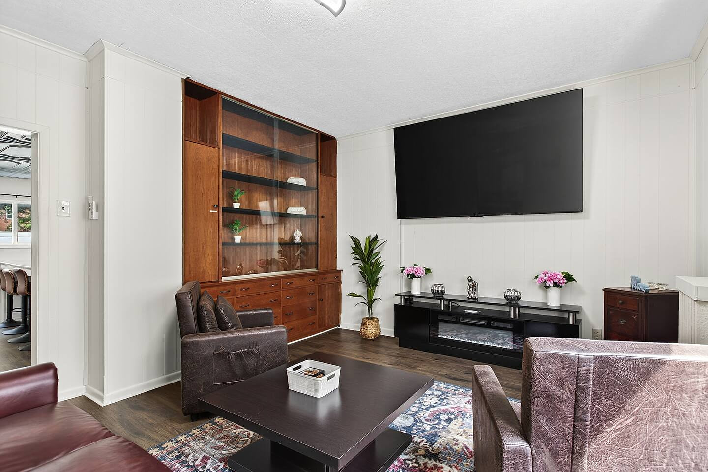 *Relax in a cozy living room with a large screen TV, a fireplace, and comfortable leather recliners, perfect for unwinding after a day of exploring.