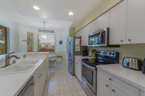Fully equipped modern kitchen with stainless steel appliances, ample counter space, and a breakfast nook. Prepare your own meals with ease in this bright, functional space.