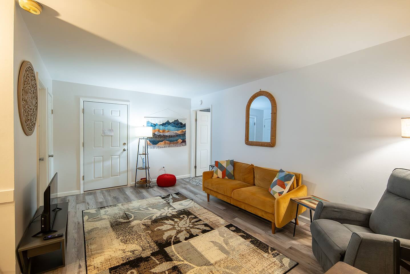 Bright and modern space with warm tones, sleek floors, and colorful accents—offering comfort and style in every corner.