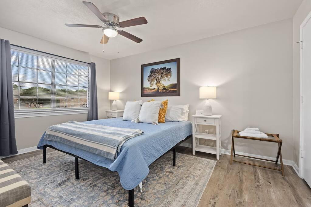 Spacious bedroom with fresh linens, and natural light for restful nights.