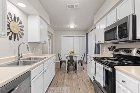 Fully stocked kitchen with stove, oven, microwave, and plenty of counter space.