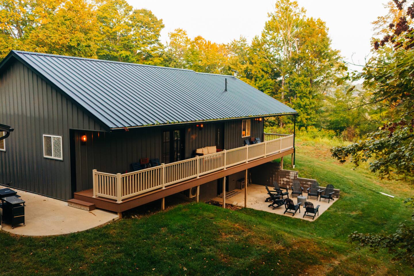 Take in the full view of the spacious deck, lower patio, and fire pit seating—plenty of cozy spots for morning coffee, sunset chats, and late-night laughter.