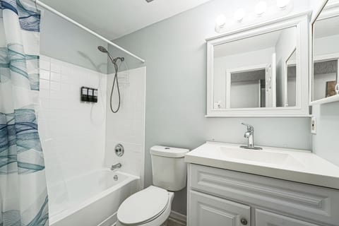 Private master bathroom with a relaxing bathtub, fresh towels, and all the essentials for a spa-like experience.
