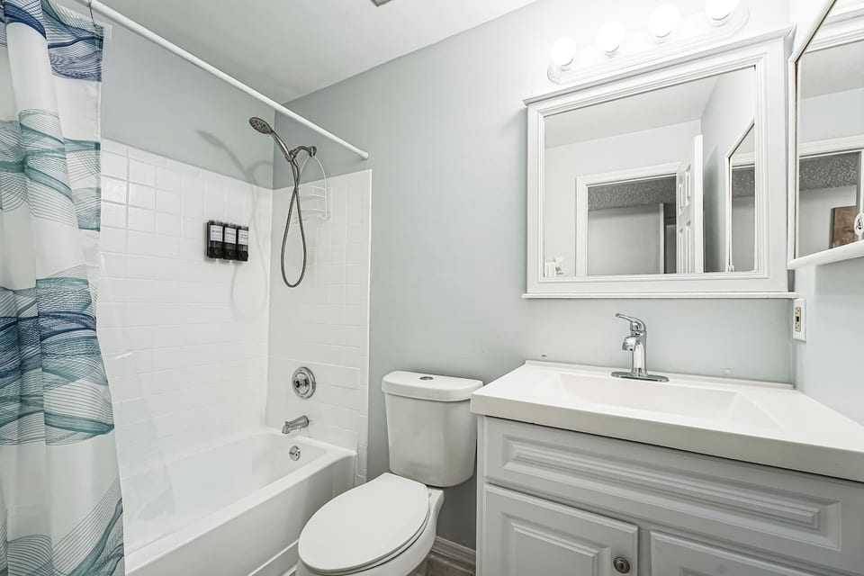 Private master bathroom with a relaxing bathtub, fresh towels, and all the essentials for a spa-like experience.