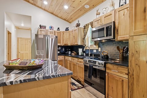 Rustic-modern kitchen with granite island and stainless appliances