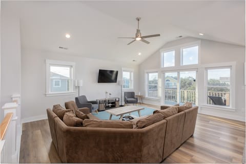 Relax in the living room, where soft seaside tones meet modern comfort. Gather on plush seating, stream your favorites on the large Smart TV, or simply unwind after a day at the beach in this bright, airy space designed for family connection.
