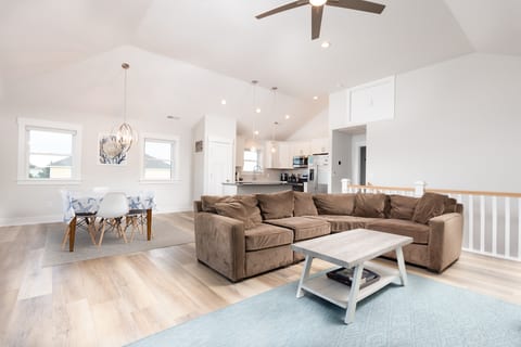 Relax in the living room, where soft seaside tones meet modern comfort. Gather on plush seating, stream your favorites on the large Smart TV, or simply unwind after a day at the beach in this bright, airy space designed for family connection.