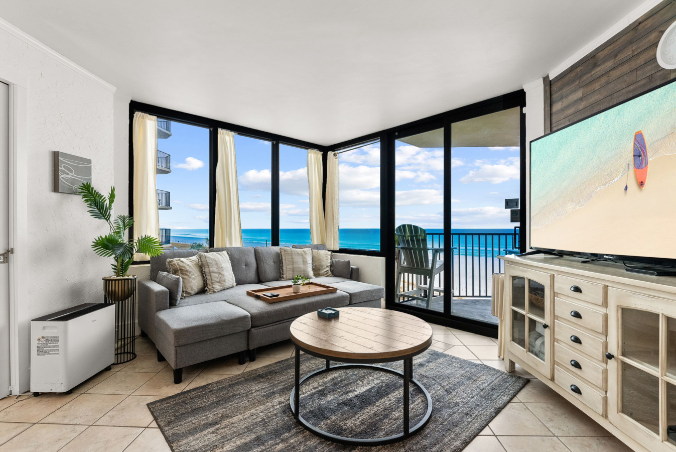 Relax in the living room with breathtaking floor-to-ceiling Gulf views