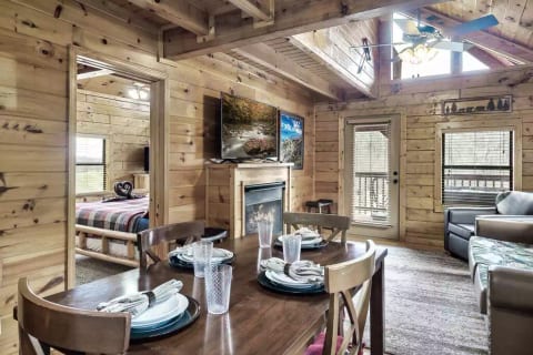 Hideaway Hangout is a beautiful log cabin. Living room has a natural gas fireplace and a 55" Roku TV, and there are 5 total Roku TVs in the cabin.