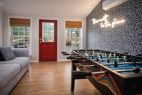 Games Room: Bright space with foosball, fun decor, and sunny windows inviting laughter and play!