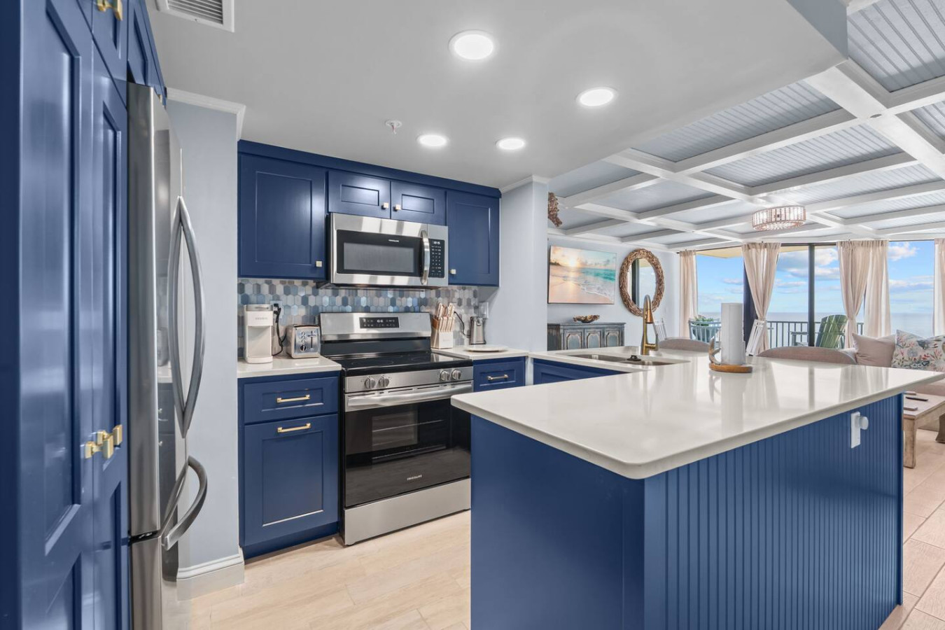 Chef’s Kitchen – Stainless appliances, quartz counters, and coastal backsplash.