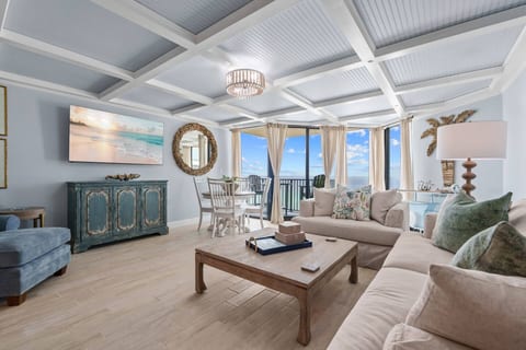 Living Room – Relax in a cozy, coastal living space with beachfront balcony access.