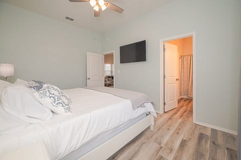 The master bedroom features a comfortable king bed with an en-suite bathroom and closet.