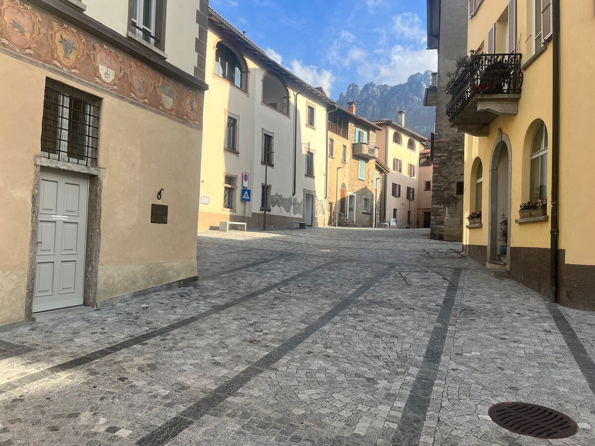 Piazza Grande in Sonvico, a charming central space surrounded by historic buildings, the beating heart of the village, ideal for strolling and socialising.
