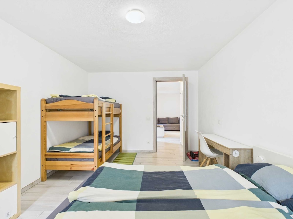 Ampia camera da letto con angolo scrivania, ideale per unire relax e lavoro. L'ambiente luminoso e ben organizzato offre un'atmosfera accogliente e funzionale, perfetta per un soggiorno che combina comfort, praticità e produttività.