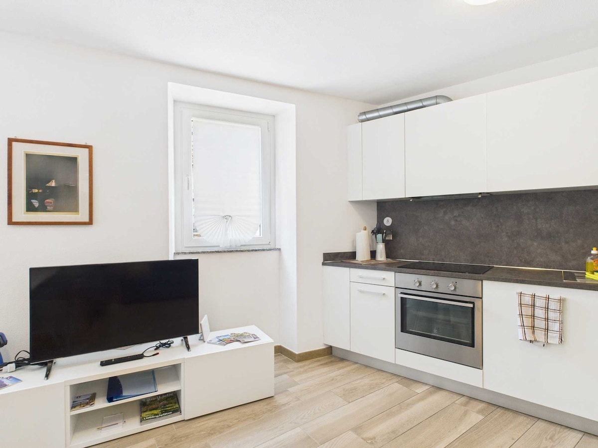 L'angolo con TV piatta è un'area accogliente, dotata di una moderna TV a schermo piatto montata a parete. Il design semplice e funzionale crea uno spazio perfetto per godersi film e programmi in totale comfort.