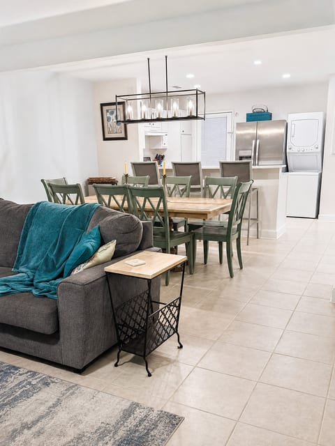 Bright open dining space with full kitchen, bar seating, and in-unit laundry