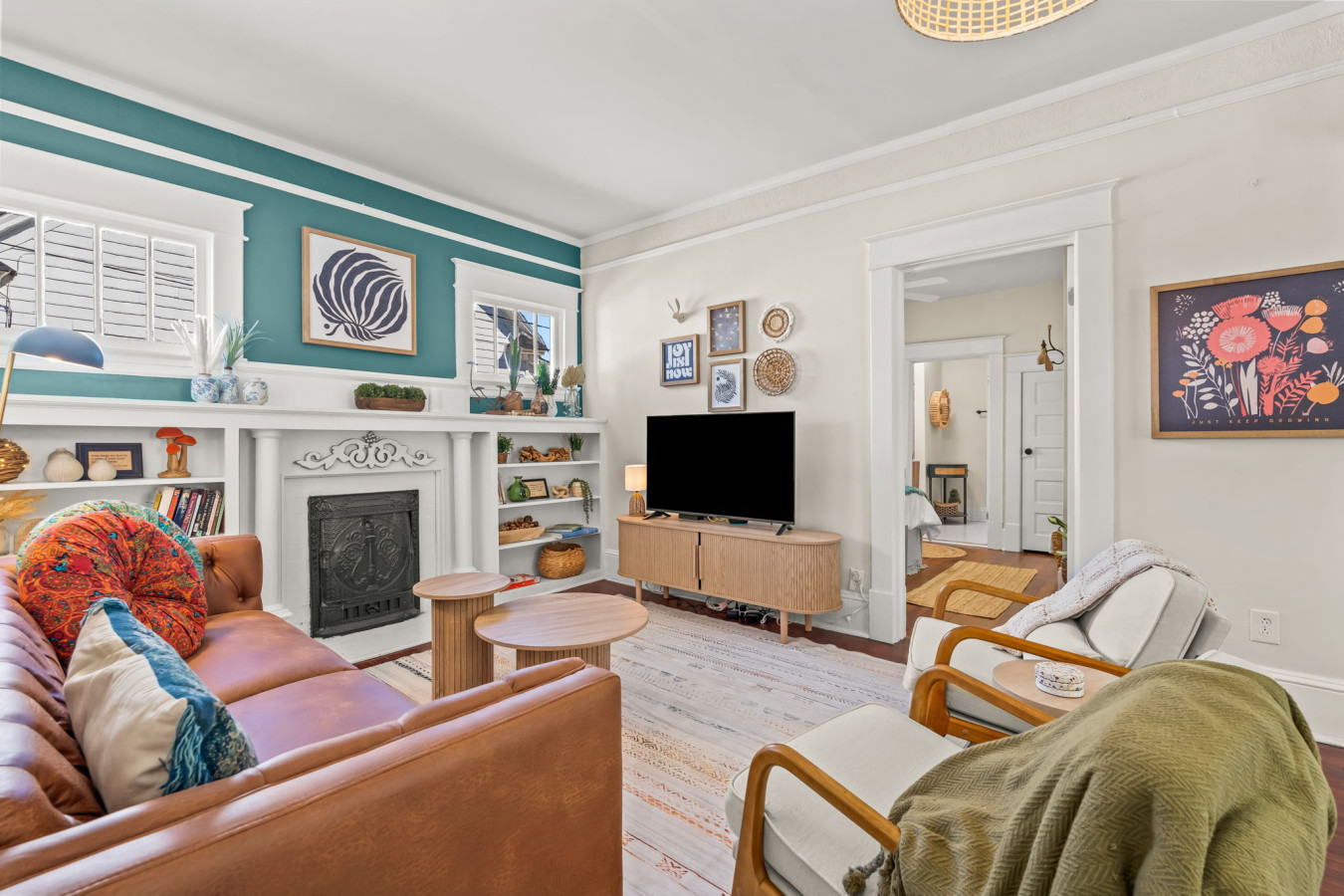 Bright, welcoming living room w/ comfy seating, playful pops of color, & an easy flow for relaxing or gathering together.