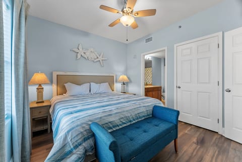 Spacious Retreat: The master bedroom offers a comfortable king bed, cozy bench seating, and convenient access to the private bath.