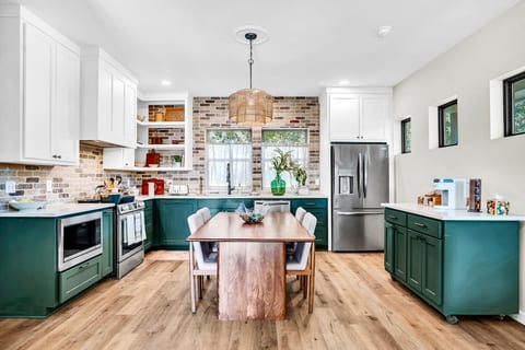 Fully equipped family kitchen! Modern appliances, coffee bar, toasters, and all the cooking basics and glassware (including wine glasses) are ready for your group. Enjoy stylish meals together at the central dining table.