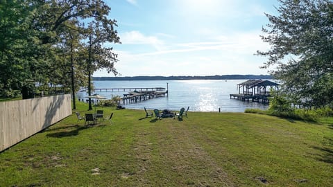 Experience stunning, open lake views right from the back lawn. Gather around the lakeside firepit under the sunset for truly magical evenings. The serene setting features mature trees and private dock access.