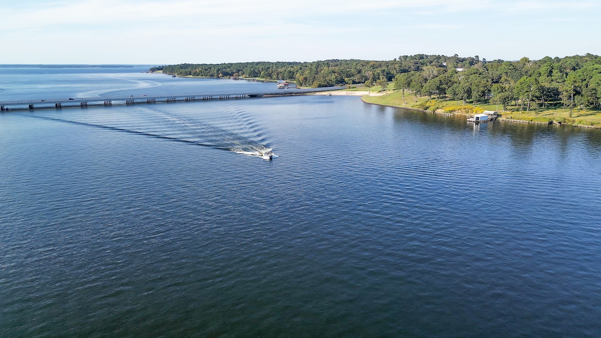 Enjoy the wide, open expanse of Lake Palestine—perfect for a full day of boating and water sports. The property's location offers easy access to the main body of water, with clear views extending to the bridge and beyond.