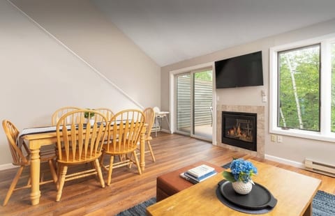 Living/dining area with gas fireplace and access to the deck.