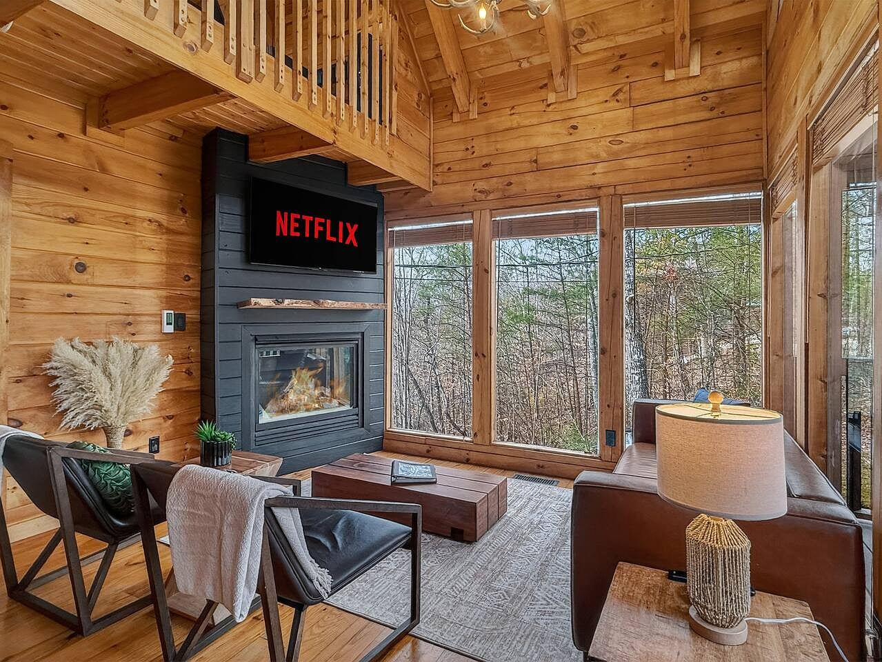 Movie nights hit different when paired with a fireplace, vaulted wood ceilings, and all the comforts of home.