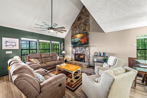 Living Room with vaulted ceilings, 70" TV, and gas fireplace and a view