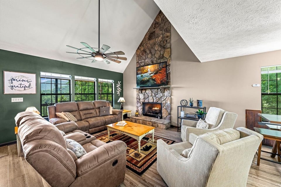 Living Room with vaulted ceilings, 70" TV, and gas fireplace and a view
