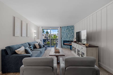 Spacious and inviting — enjoy a movie night on the smart TV or watch palm trees sway through the large windows. Slide open the balcony door to let in the ocean breeze and natural light while you relax or gather together.