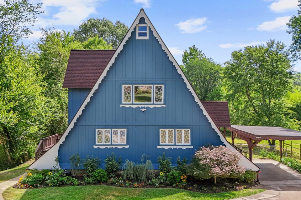 Escape to the Riverpoint, this unique house embodies the charm of a Swiss chalet A-Frame, complemented by a picturesque boathouse on the serene Canal of the Port Tobacco River.
