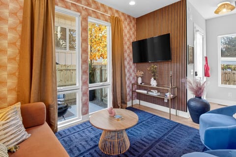 Living Room | Bold Design | Natural Light
A stylish lounge featuring patterned accent walls, warm curtains, and floor-to-ceiling windows that brighten the vibrant, modern seating area.