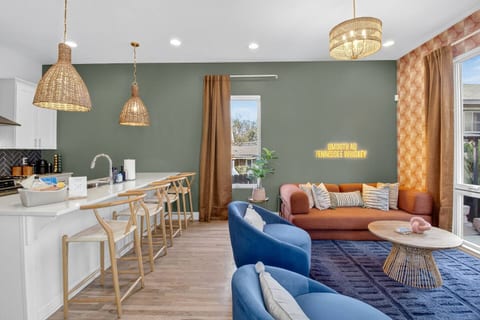 Kitchen + Living Room | Open Layout | Stylish & Social
An airy, modern space featuring woven pendant lights, bar seating, and a cozy lounge area with bold colors — perfect for cooking, chilling, and entertaining together.