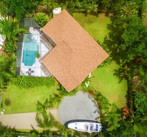 Welcome to your private escape! This aerial view shows off the expansive grounds. For a sense of scale, that's a 32-foot boat parked in the driveway with plenty of room to spare.